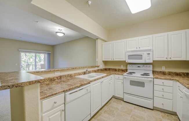 a kitchen with white cabinets and white appliances