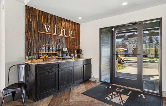 A bar area with a wooden backdrop and a chair in front of it.