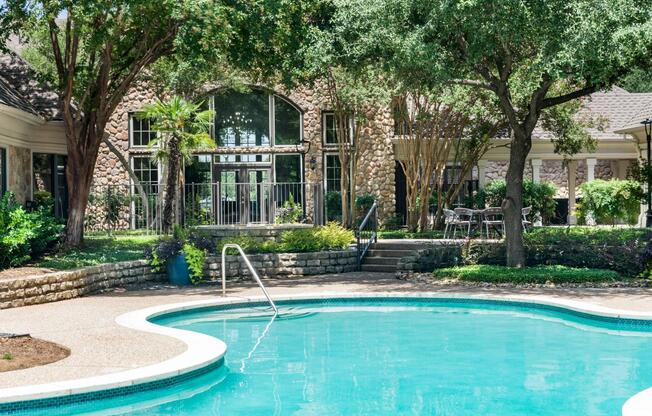 Cool off or unwind in the sparkling swimming pool surrounded by mature trees and peaceful outdoor seating areas.