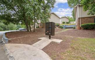 A black parking sign is in the middle of a grassy area.