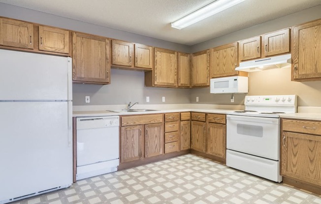 Kitchen with white appliances and lots of cabinet storage at Northridge Heights in north Lincoln