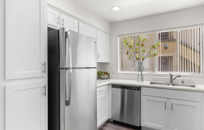 a kitchen with a sink and a refrigerator