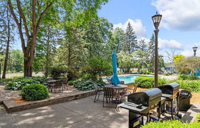 a patio with tables and chairs and a swimming pool