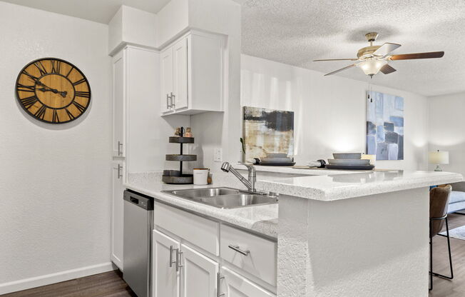 a kitchen with a clock at the top of a table