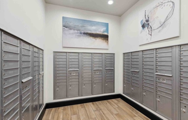 a large locker room with lockers and a painting on the wall