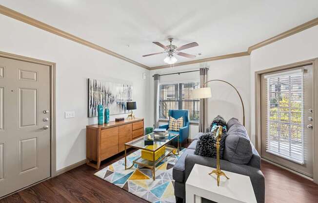 A living room with a grey couch and a yellow coffee table.