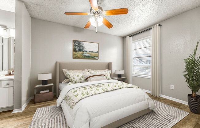 a bedroom with a bed and a ceiling fan