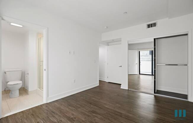 Bedroom with Mirrored Closet, Vinyl Flooring, Recessed Lighting, and Bathroom