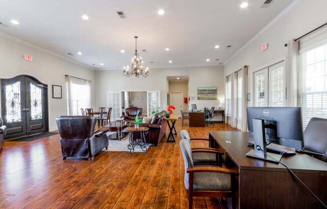 A large room with a wooden floor and a chandelier hanging from the ceiling.