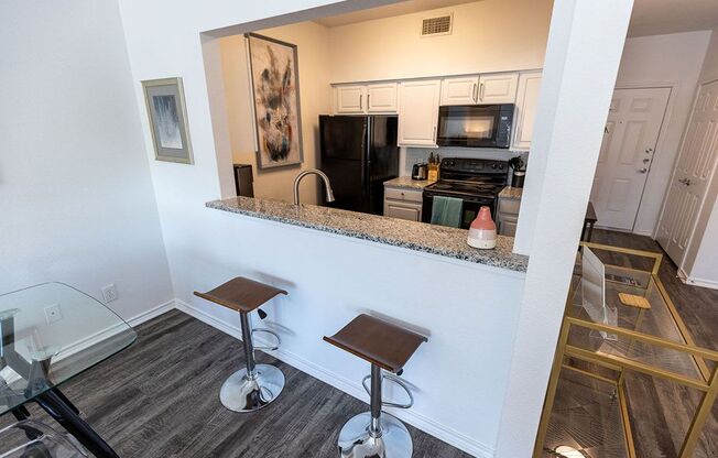 a view of the kitchen and living room from the balcony