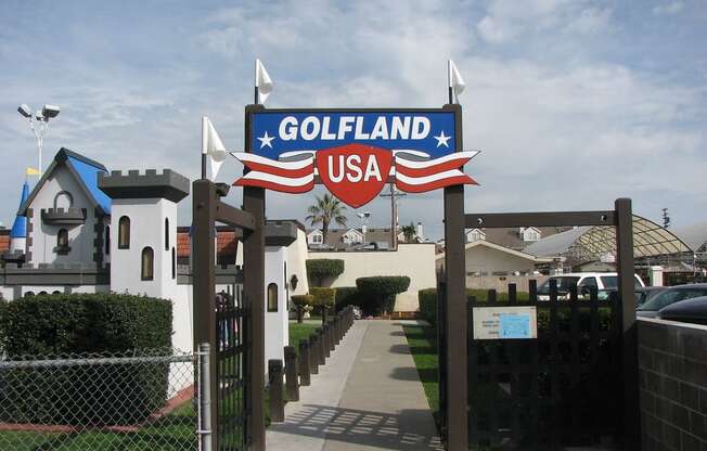 a sign for the golf land usa in front of a house