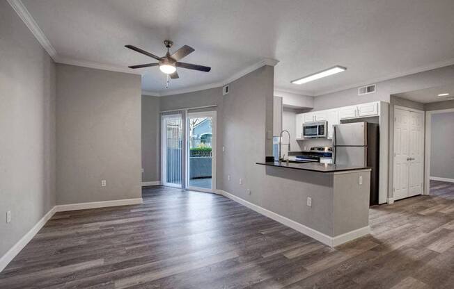 A kitchen area with a bar and a refrigerator.