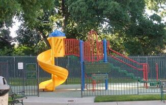 a childrens playground with a large yellow slide