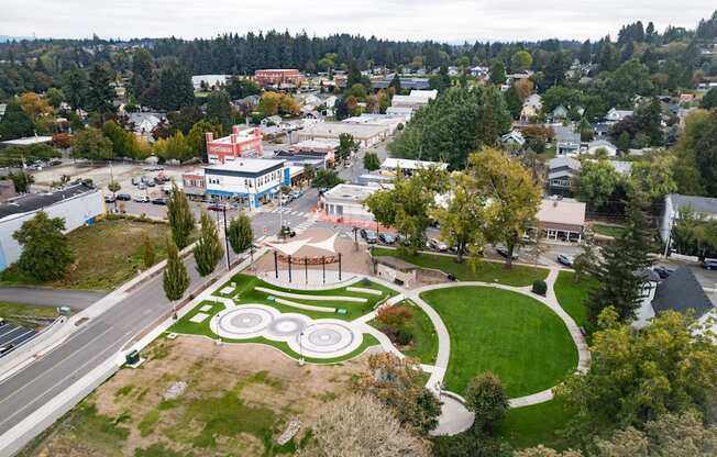 A park with a circular design in the middle of a town.
