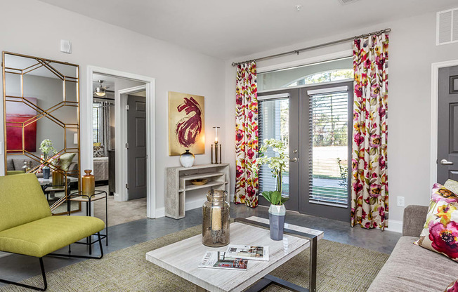 a living room with a yellow couch and red curtains and a fireplace