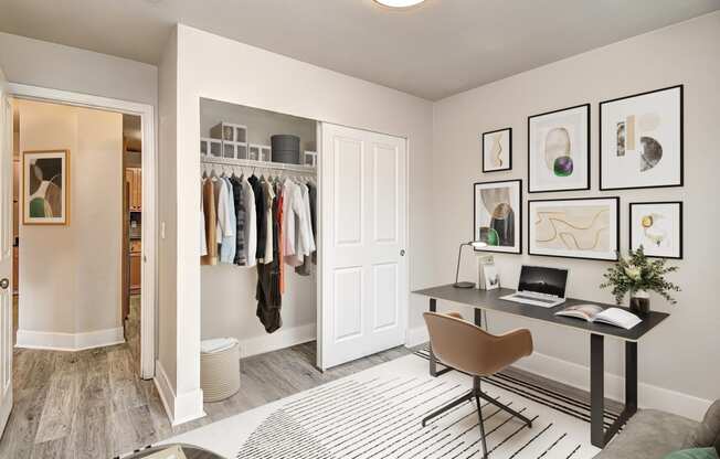 a closet in a bedroom with a desk and chair