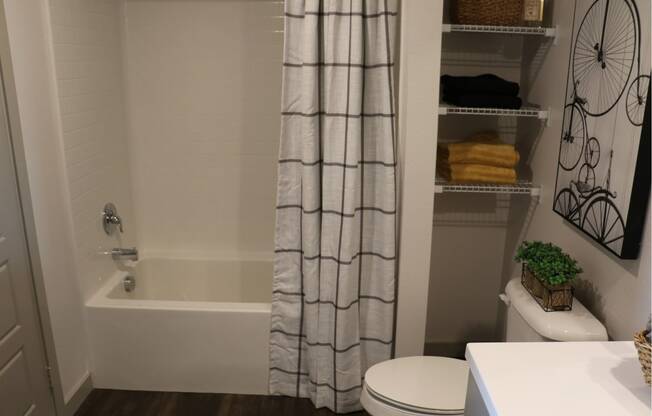 a bathroom with a shower and a toilet and a shower curtain