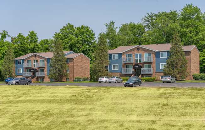 an aerial view of an apartment building with a grass field