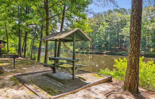 a picnic table next to a body of water