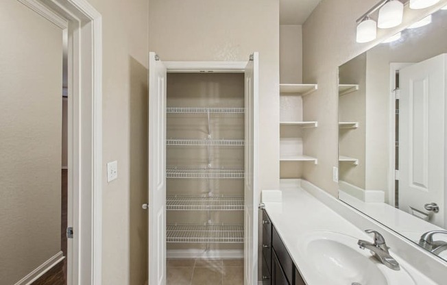 a bathroom with a shower and a sink and a mirror