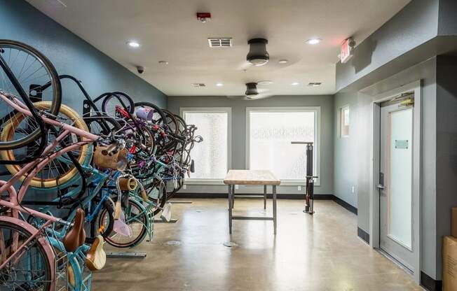 a room with a bunch of bikes on the wall