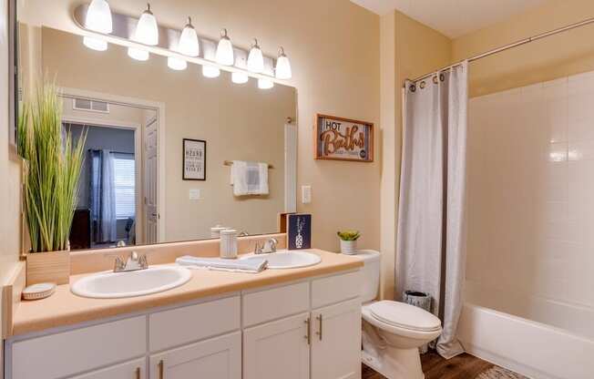 a bathroom with a toilet sink and shower