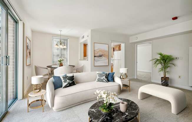 a living room with a white couch and a round table