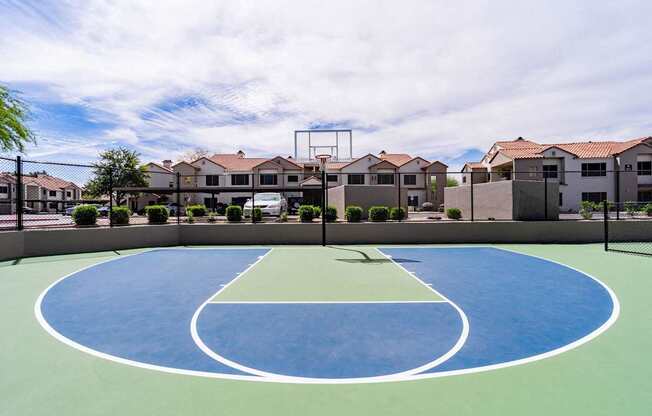 A basketball court in the middle of a housing complex.