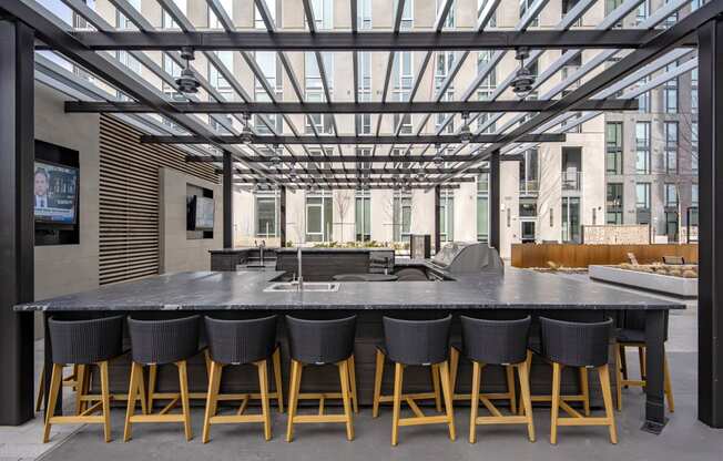 a large rectangular table with black chairs in a room with glass ceilings