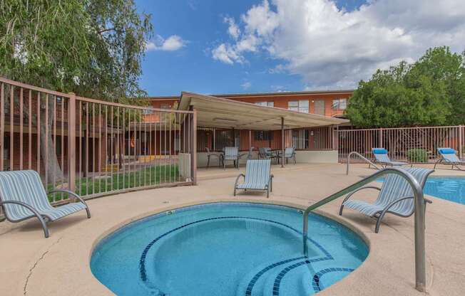 A small pool with a metal fence around it.
