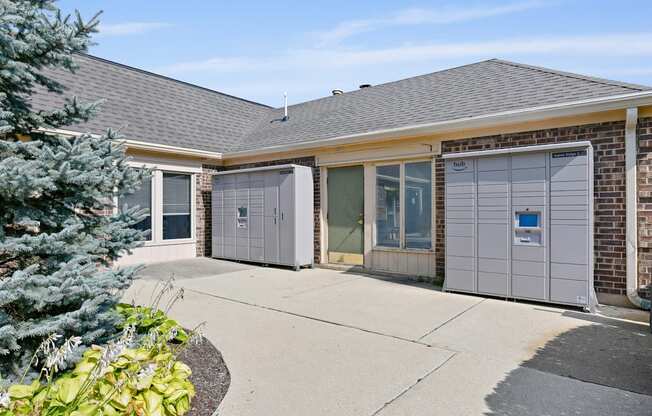 the front entrance of a brick house with two garage doors