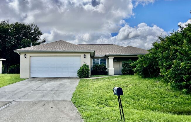 Charming 3BR Home with 2-Car Garage & Lawn Care Included in Lehigh Acres!