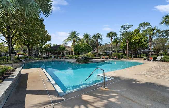 Community Swimming Pool with Pool Furniture at Fountains Lee Vista Apartments in Orlando, FL.