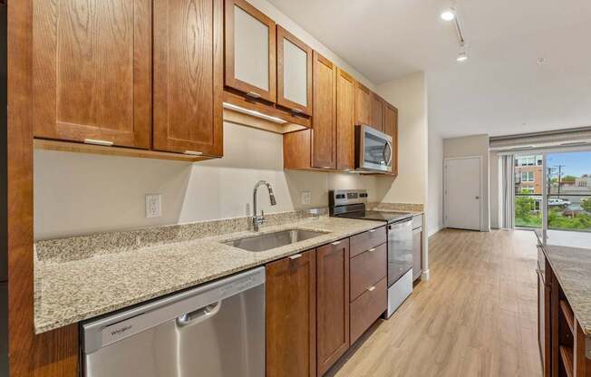 A kitchen with wooden cabinets and a granite countertop.