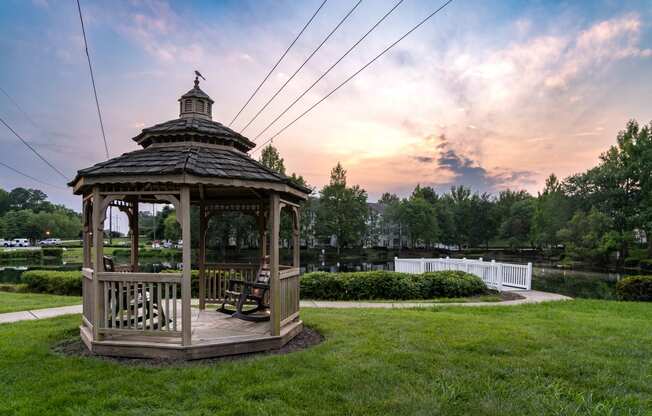 a gazebo with a sunset in the background