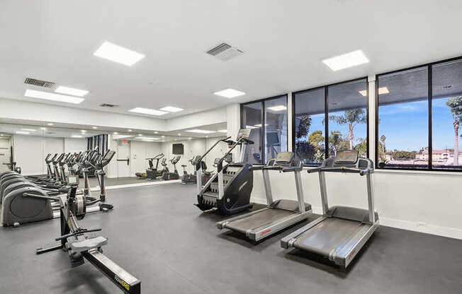 Community Fitness Center with Equipment at Madison Park Apartments located in Anaheim, CA.