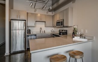 Fitted Kitchen With Island Dining at The Tower Apartments, Alabama, 35401