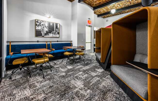 a lounge area with tables and chairs and a television