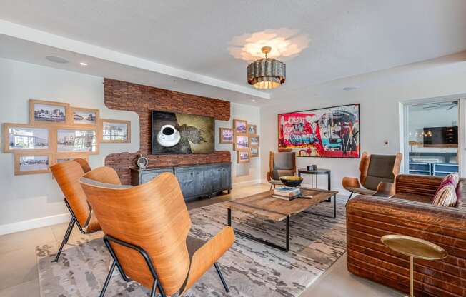 a living room with a couch and chairs and a tv