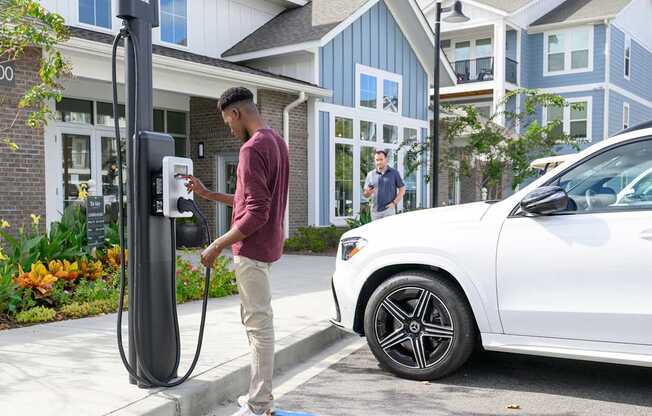 a man is charging his car at a gas pump