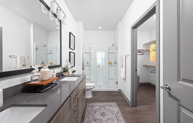 a bathroom with a shower and a sink and a mirror at Palm Grove in Ellenton, FL 34222