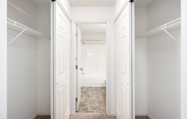 a closet in a bedroom with white doors