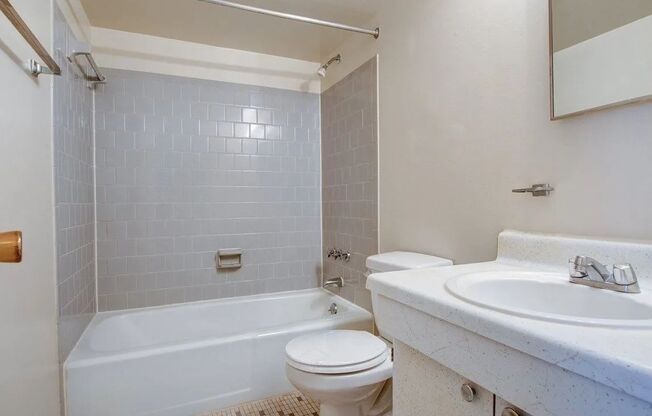 Large bathroom with subway tiled shower