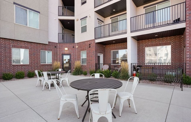 our apartments have a large patio with tables and chairs