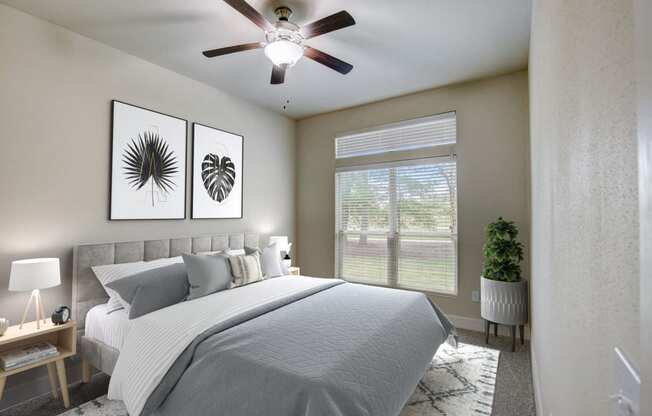 a bedroom with a large bed and a ceiling fan