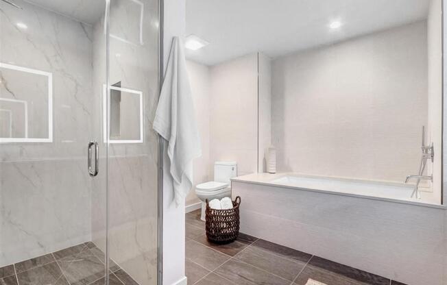 a white bathroom with a shower and a tub