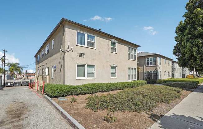 A building with a grey facade and a red line on the sidewalk.