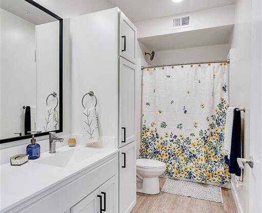 a bathroom with a toilet and a sink and a mirror