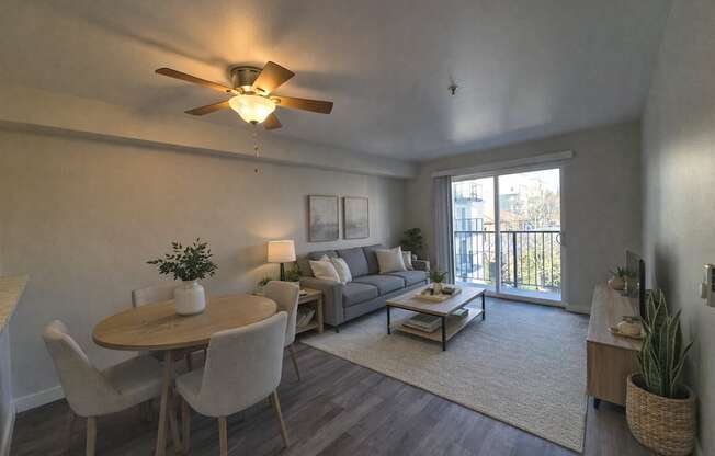 A living room with a dining table and chairs.