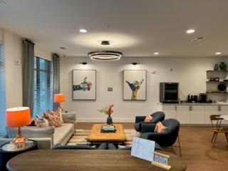 A living room with a sofa, armchairs, and a coffee table.